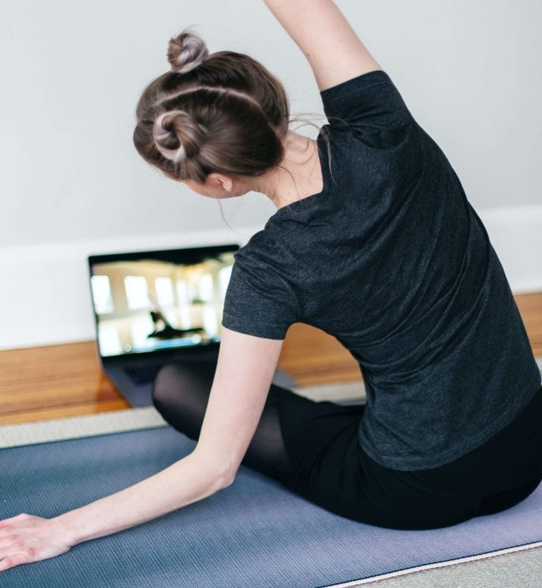 Fit girl teaching yoga online during quarantine