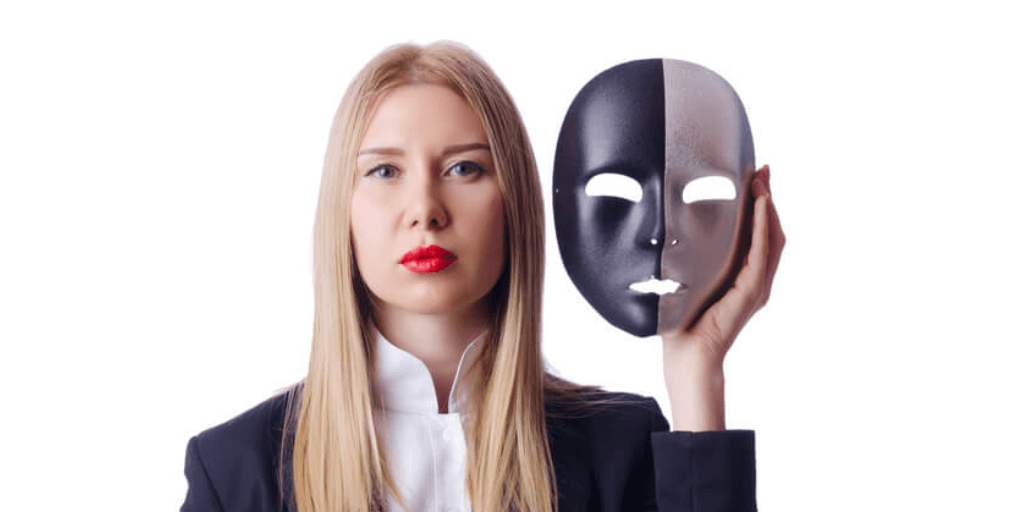 Business woman with a mask symbolizing the concept of imposter syndrome at work.
