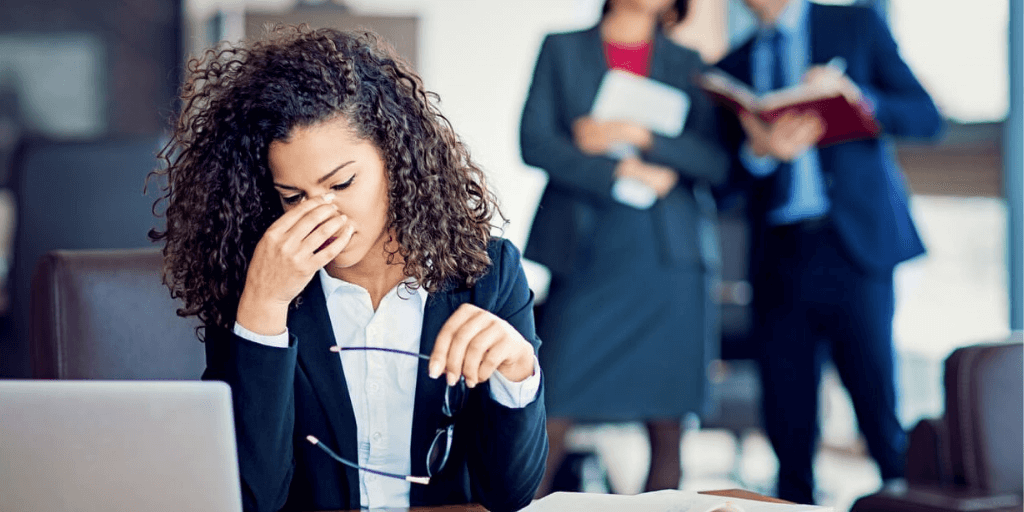 Woman employee stressed out from being bullied at work