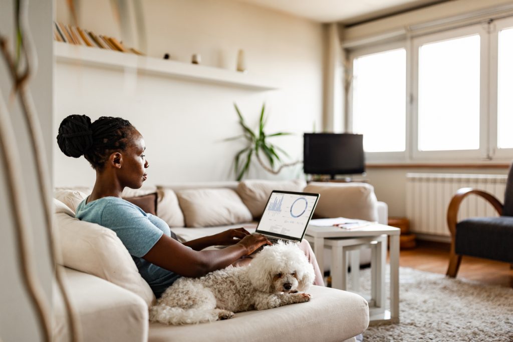 African-American woman doing data entry at home due to pandemic isolation