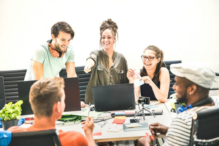 marketing interns discussing their ideas during a team meeting