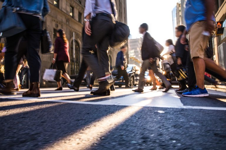 People going to work, walking across the crosswalk in NYC.