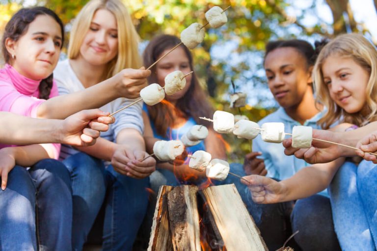 Kids at summer camp roasting marshmallows/