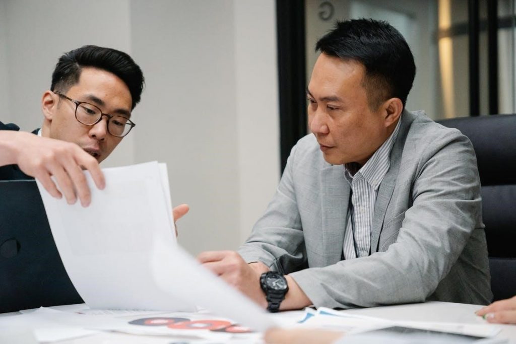 Two hiring managers looking at resumes