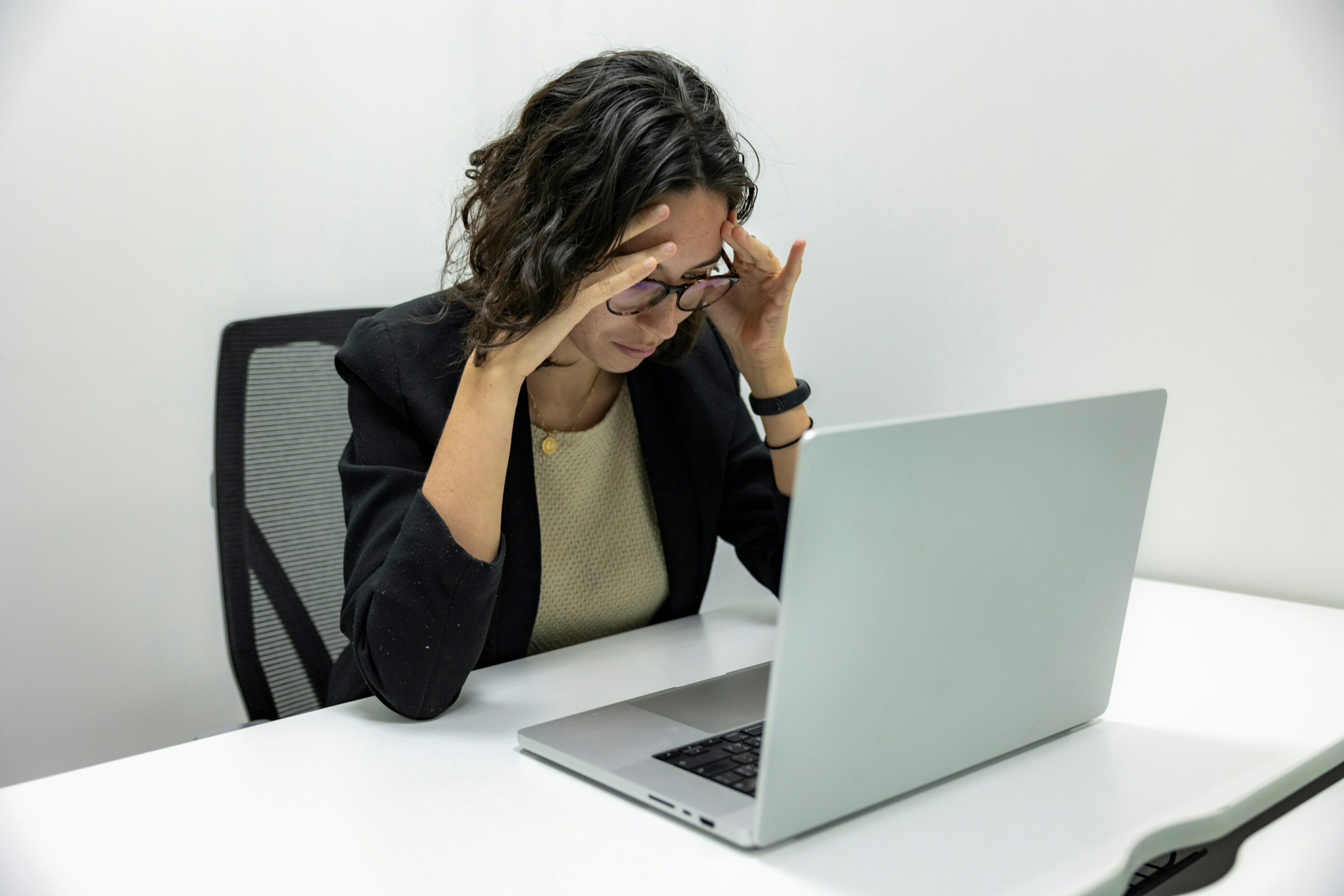 woman looking at a laptop feeling stressed out